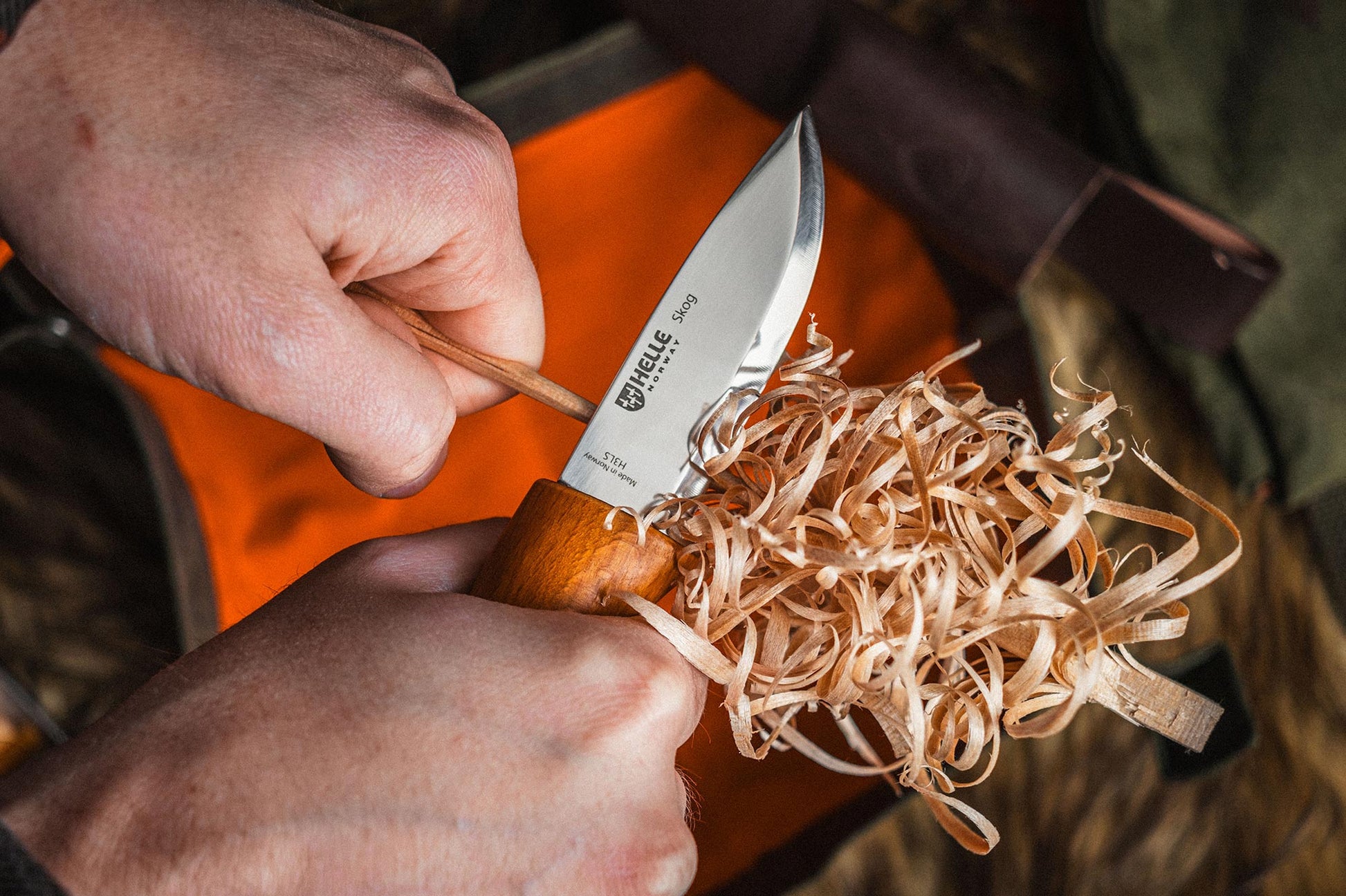 Helle Skog Fixed Blade Carving Knife in Hand in Use Featherstick
