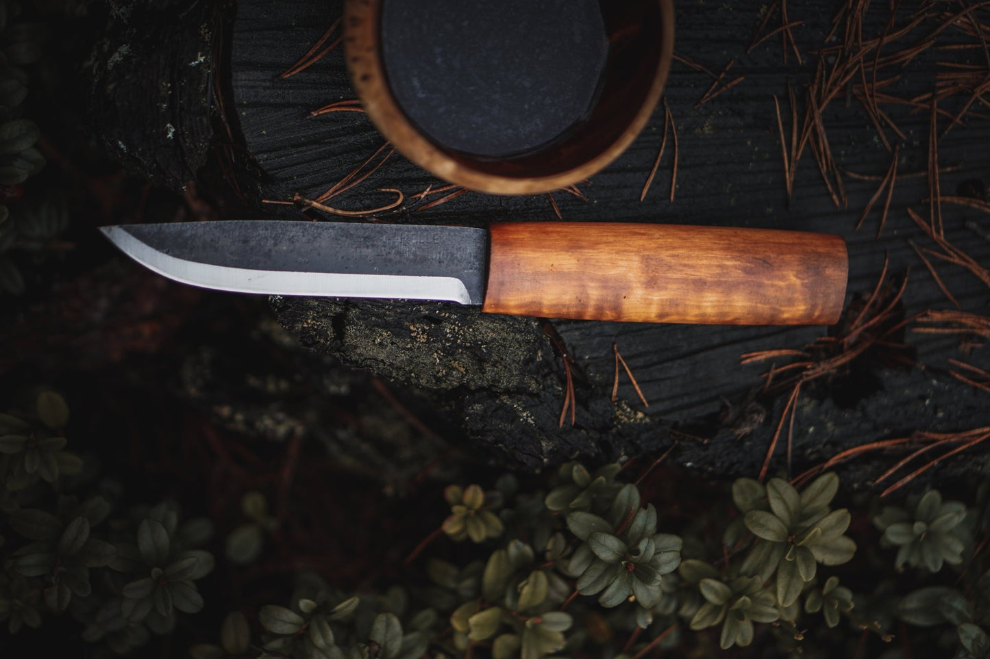 Helle Viking Fixed Blade Knife on stump with kuksa