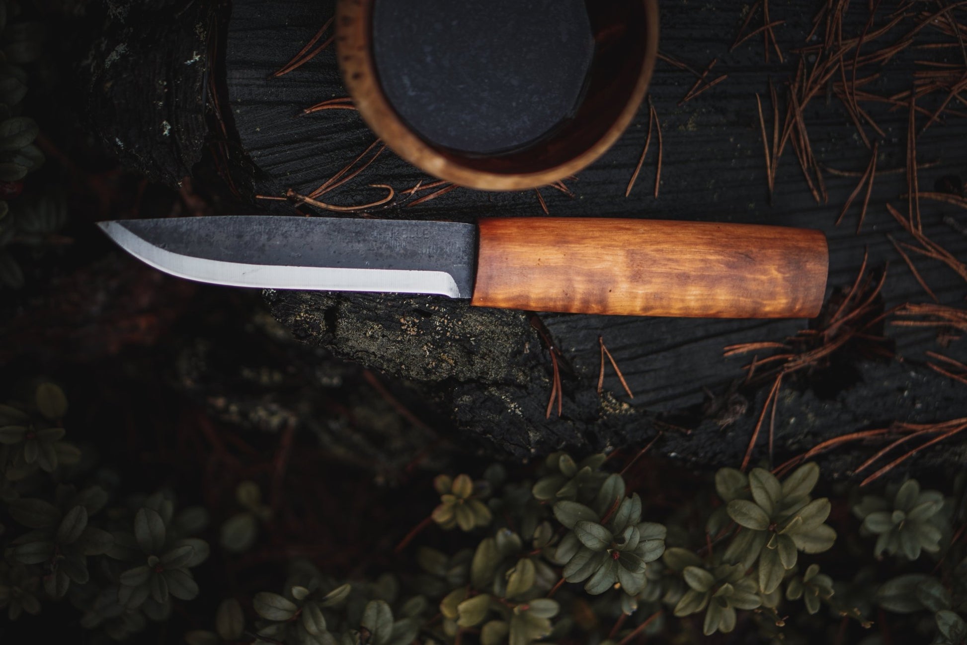 Helle Viking Fixed Blade Knife on stump with kuksa