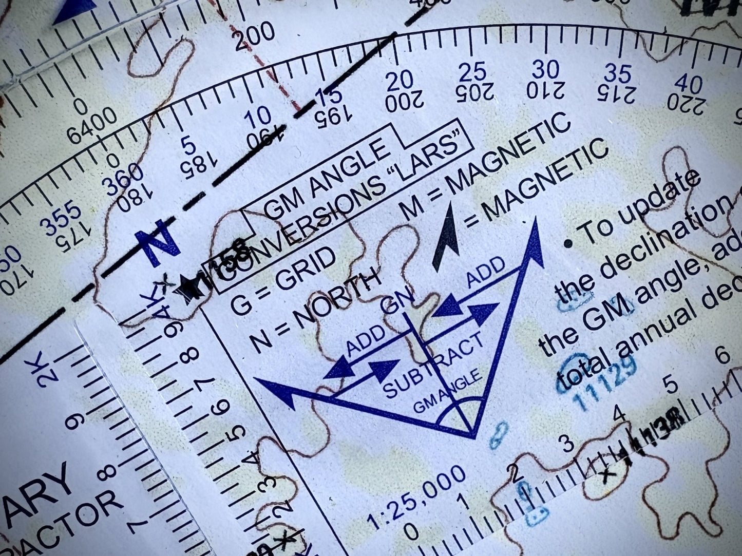 Round Military Protractor Coordinate Scale on Topographic Map close up