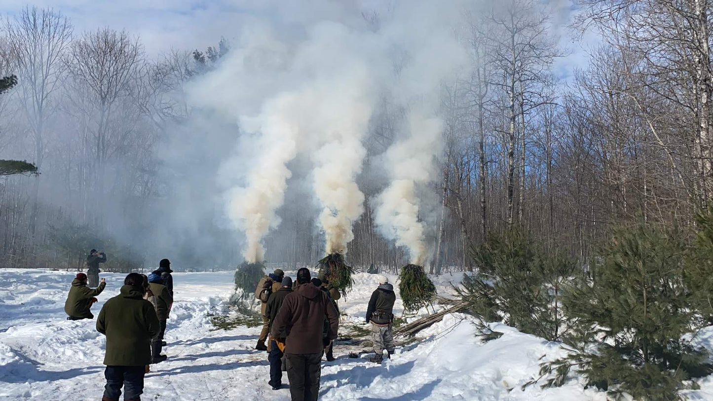 Winter Survival Course — Gray Bearded Green Beret Survival School Students Building Signal Fires in Snow