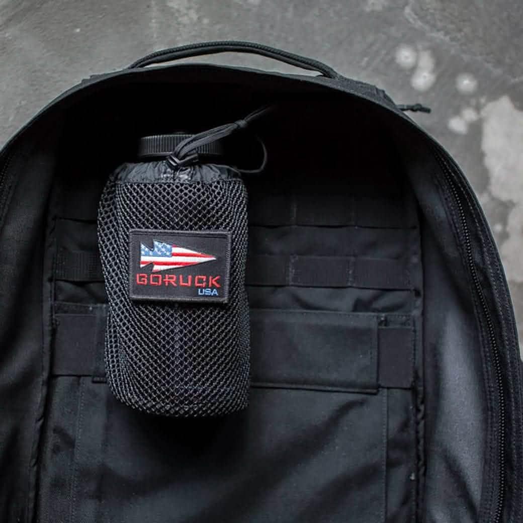 Black GoRuck rucksack with mesh water bottle pocket attached to the inside of the ruck