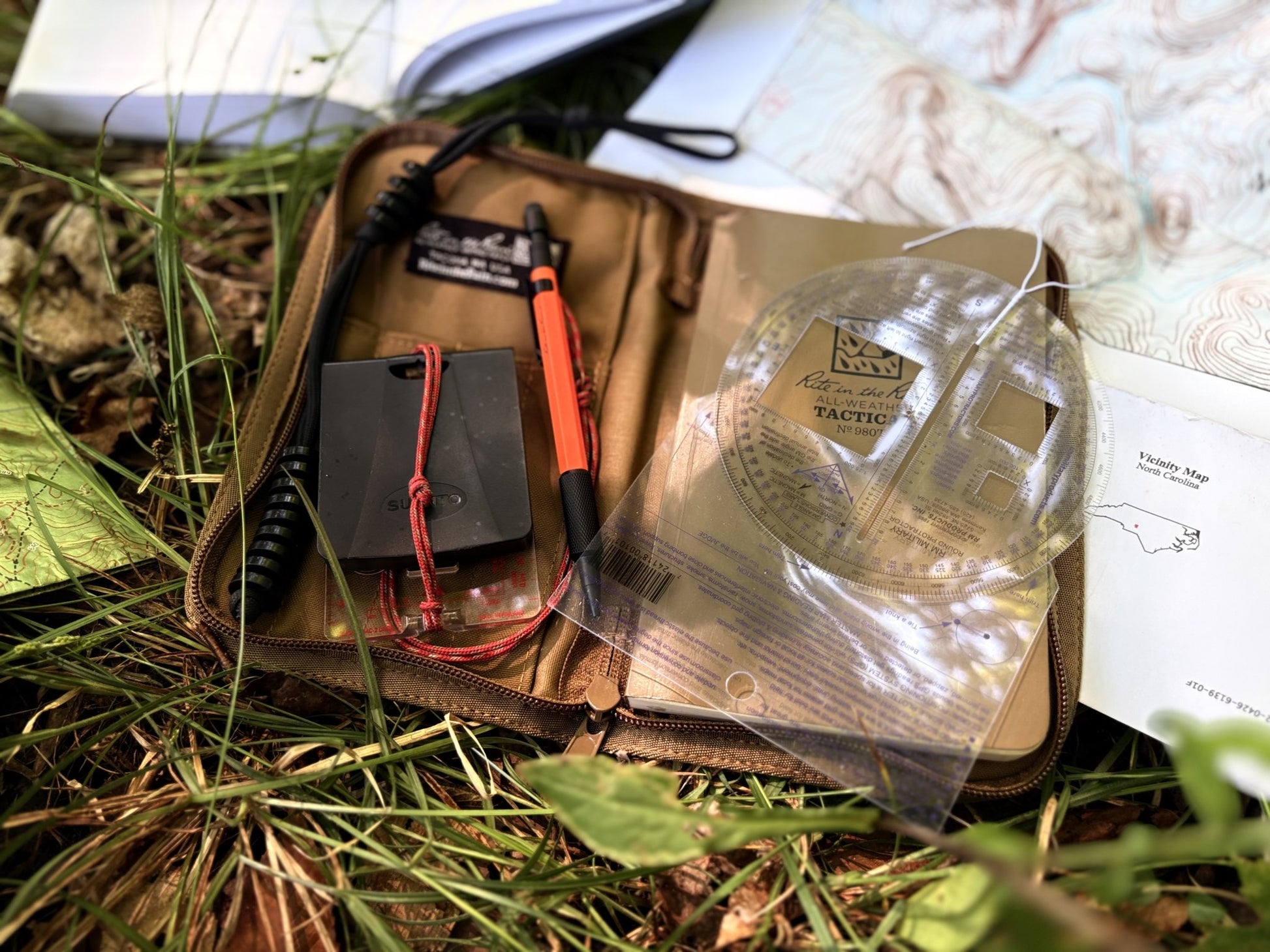Kit with tools and a map on grass