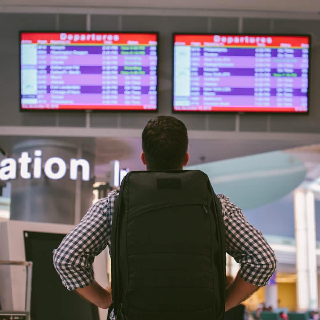 Man wearing a black GoRuck rucksack at the airport