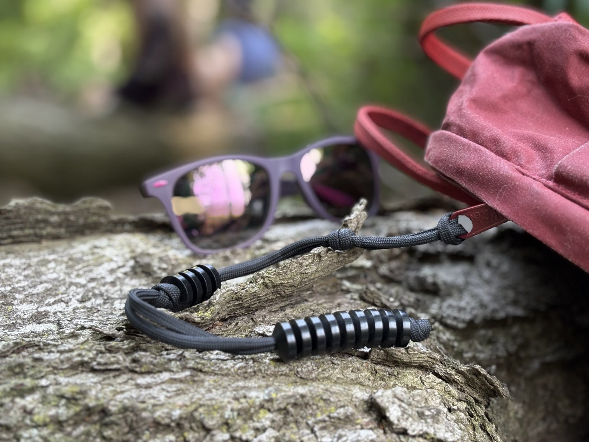 GB2 Ranger Pace Counter: Accurate Manual Distance Tracking Tool for Land Navigation on log with sunglasses and backpack