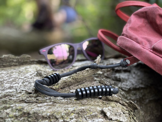 GB2 Ranger Pace Counter: Accurate Manual Distance Tracking Tool for Land Navigation on log with sunglasses and backpack