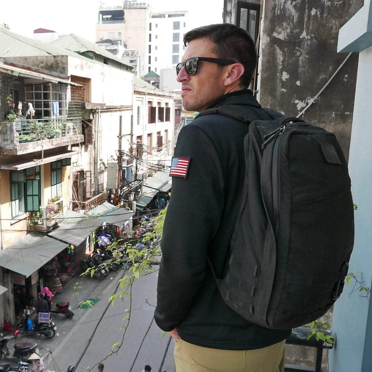 Man wearing black GoRuck rucksack in an urban environment
