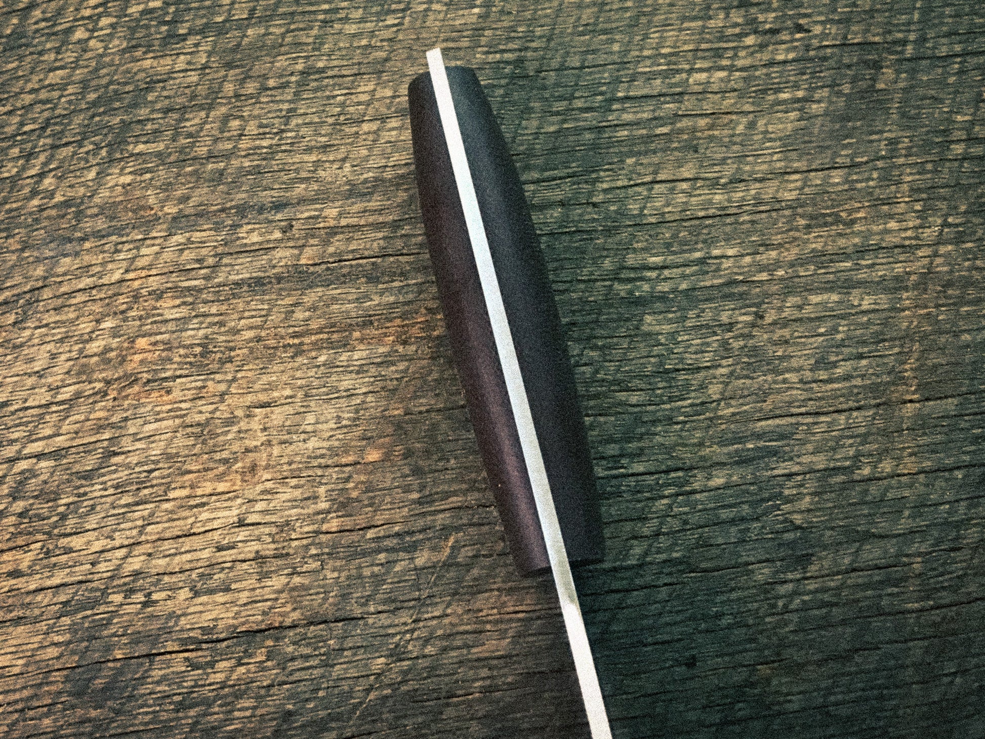 Knife blade on a wooden surface