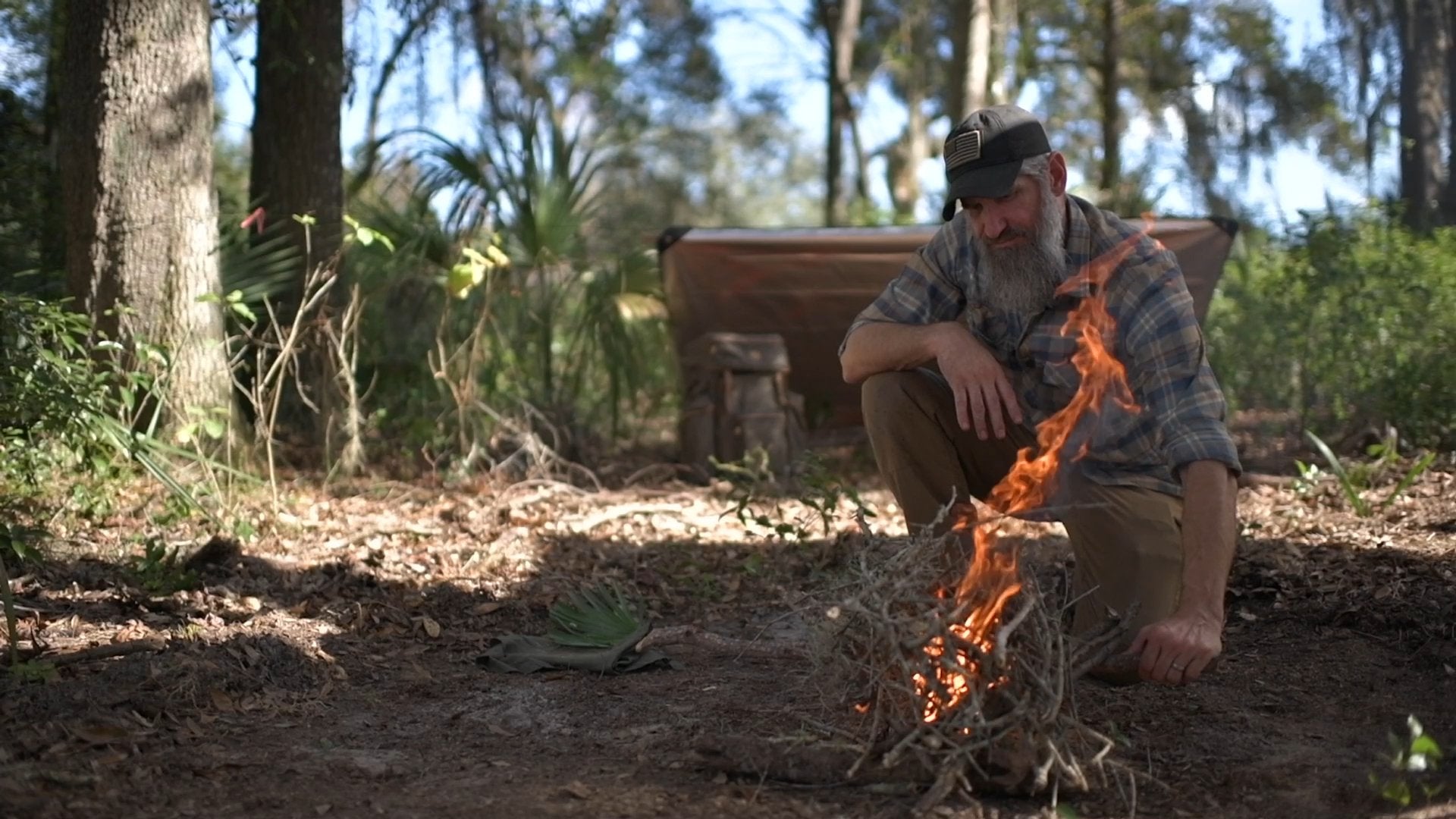 Into the Woods: Wilderness Survival Training Film with Joshua Enyart – Streaming, USB, and DVD Options Tarp Shelter and Fire Lay