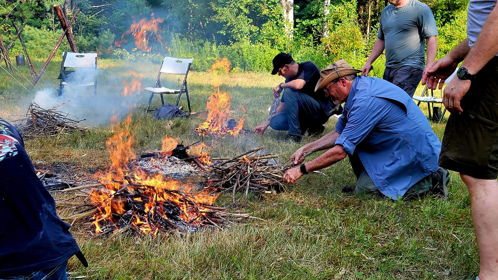 Wilderness Survival Course — Gray Bearded Green Beret Survival School Students Daytime Fire Building Field Training