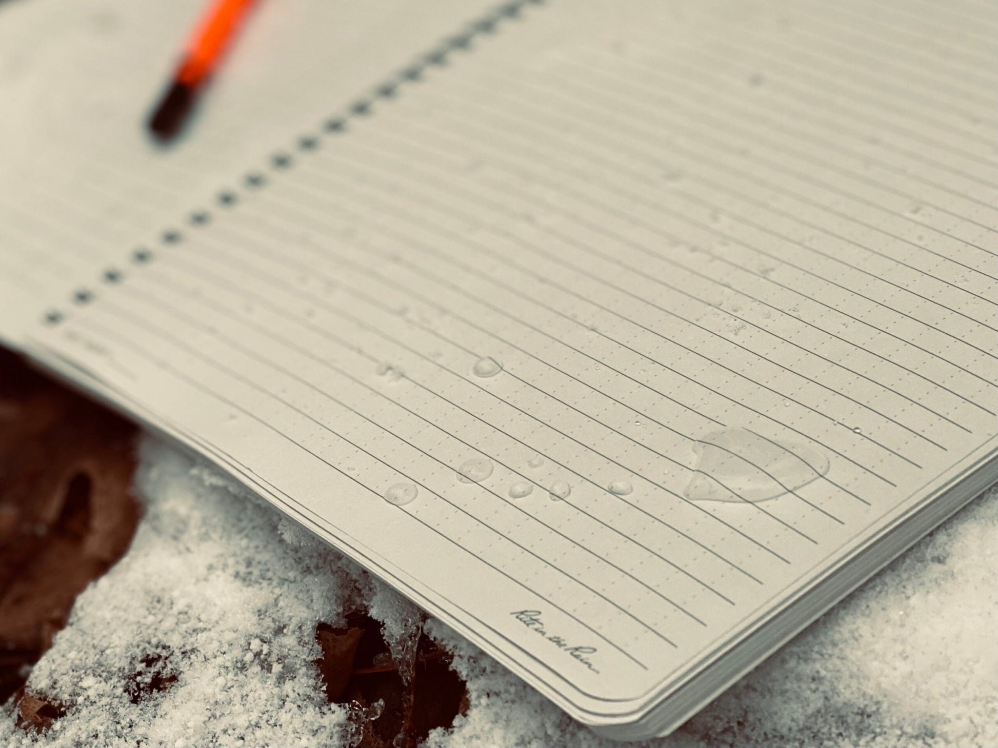 Waterproof Rite In The Rain Notebook: Your Go-To Outdoor Writing Companion 8.5x11 paper shedding water in snow